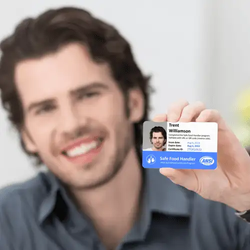 A man displaying a blue and white ID card, indicating his identification and personal information.
